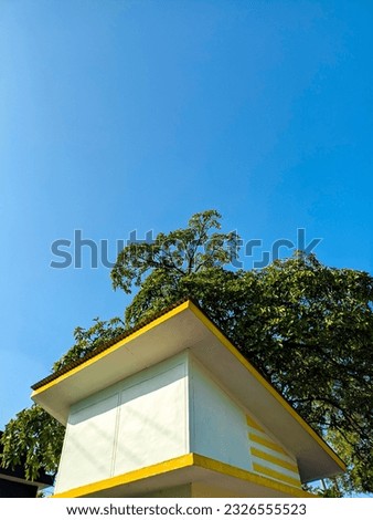 guard post building sheltered by a tree
