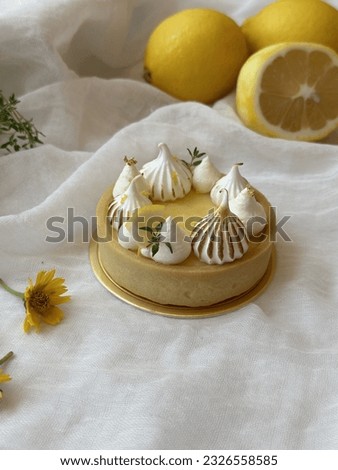 Lemon Meringue Tart is tangy and sweet. Dessert on a white plate. Free space for text. Yellow flower background. Menu cafe and coffee shop