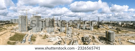big construction site with apartment buildings under construction. panoramic aerial view in sunny summer day.