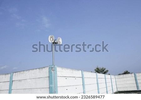 Turn on the loudspeaker for announcements in the open area. blue sky background. outdoor information tool.