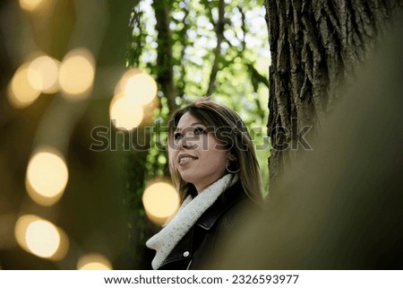 girl posing in the forest in a black jacket