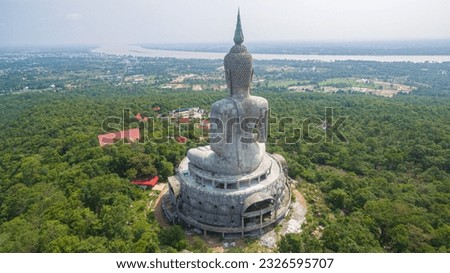 
aerial view Big white buddha statue on mountain for thai people travel visit and respect 
praying at Wat Roi Phra Phutthabat Phu Manorom on May 15, 2017 in Mukdahan, Thailand.

