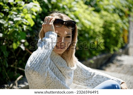 Young girl posing with sunglasses