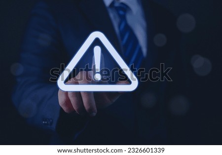 Businessman or employee with warning triangle sign for warning error Hack Alert System Warning cyber attack