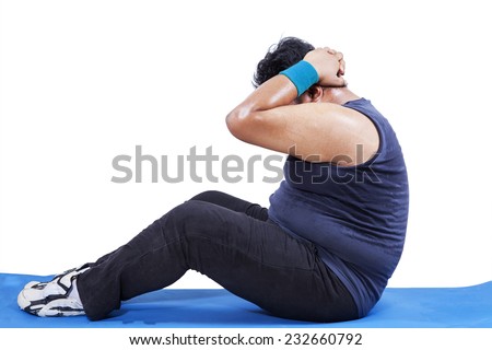 Side view of man doing workout to lose weight in studio, isolated over white