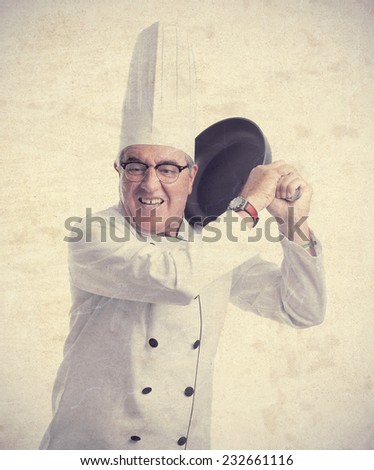 senior cool man cheff with a pan
