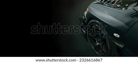 Front of black modify car on black background,copy space	 Royalty-Free Stock Photo #2326616867
