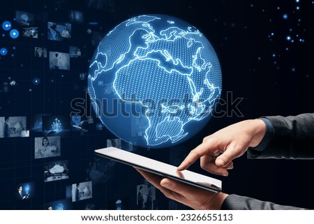 Connecting businesspeople, video conference concept. Close up of businessman hand pointing at cellphone with blue globe, grid and images on blurry background