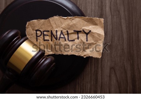 PENALTY wording with gavel on wooden background. Law conceptual