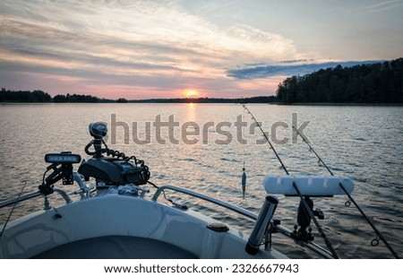 Beautiful sunset under the boat fishing session Royalty-Free Stock Photo #2326667943