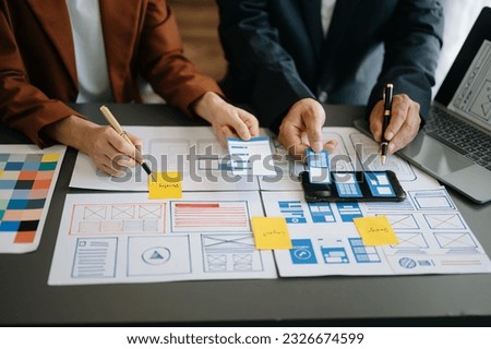 UX graphic designer planning application process development prototype wireframe for web smart phone. Creative digital development agency. in office

