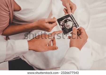 Concept Motherhood and Pregnant, Prenatal care and pregnancy. Male doctor showing ultrasound picture to pregnant woman with pregnant woman in hospital. Royalty-Free Stock Photo #2326677543