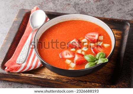 Tomato and strawberry gazpacho soup on a wooden board close-up on the table. Horizontal
 Royalty-Free Stock Photo #2326688193