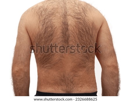 Hairy back of a young man isolated on white background.