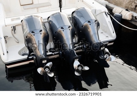 Three outboard boat motor. Selective focus. Royalty-Free Stock Photo #2326719901