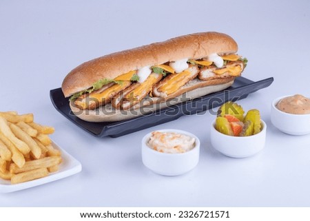 Cordon bleu sandwich with cheese, fries and coleslaw and pickled plate,Horizontal shoot on white background Royalty-Free Stock Photo #2326721571