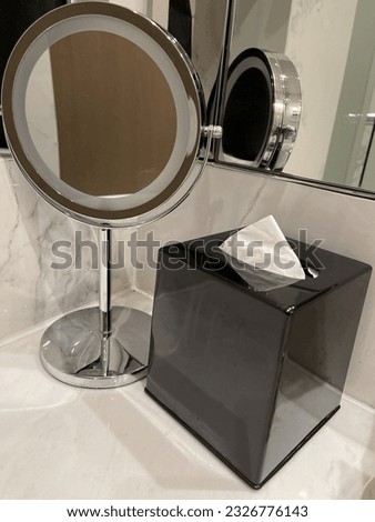 Mirror and a box of tissue in the corner of bathroom. Photo taken in Bogor, Indonesia. 2023.