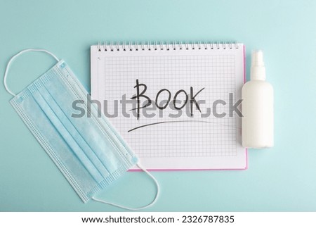 top view open copybook with mask and spray on the blue desk notepad copybook school wrtitings