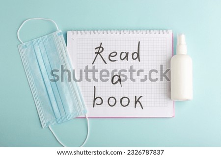 top view open copybook with mask and spray on the blue background notepad copybook school wrtiting