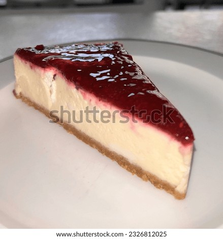 Cheesecake on the white plate, cheesecake with raspberry.