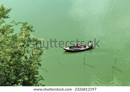 A boat with a boatman in a lake