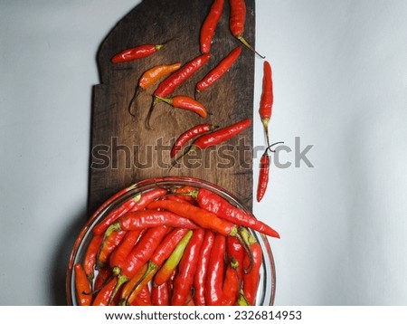 red chili on cooking board, isolated on white background. herbs. suitable for banners, posts, social media, news, food media
