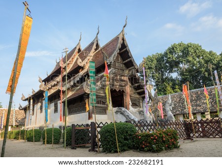 Ancient wooden teak temple of Lanna architecture with fine woodcarvings and gilded stucco in Chiang Mai, Thailand
