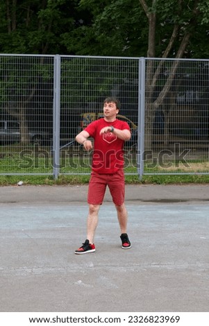 The guy plays basketball on the street playground in the Kharkov yard