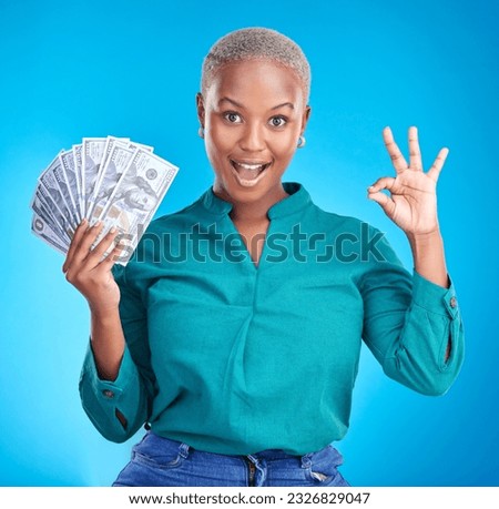 Woman portrait, okay sign and money fan for bonus, financial success and winning, finance loan with wow. African person or winner surprise, yes and notes or cash profit on a studio, blue background Royalty-Free Stock Photo #2326829047