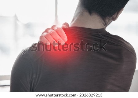 Hand, back pain and injury with the shoulder of a man in red highlight during a fitness workout. Healthcare, anatomy and emergency with a male athlete holding a joint after an accident in the gym Royalty-Free Stock Photo #2326829213