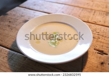 A plate of potato and edamame soup.