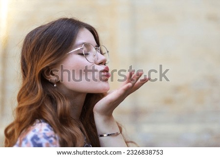 Air kiss, portrait of a young woman in profile.