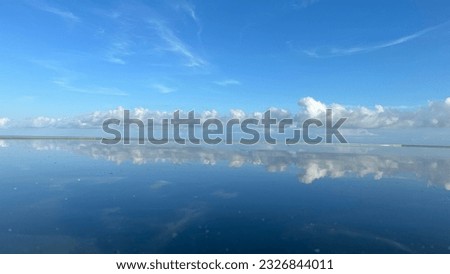 Blue sky and Cloud with water mirroring this picture take at 4 o’clock evening