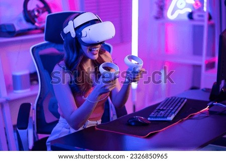 Asian young Esport woman gamer use technology VR glasses and play game. Attractive beautiful female gaming player wear virtual reality headset, feel excited and enjoy broadcast live stream online game
