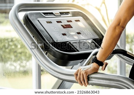 Male runner hands holding treadmill sidebar prepare for running in fitness gym. Indoor cardio workout machine Royalty-Free Stock Photo #2326863043