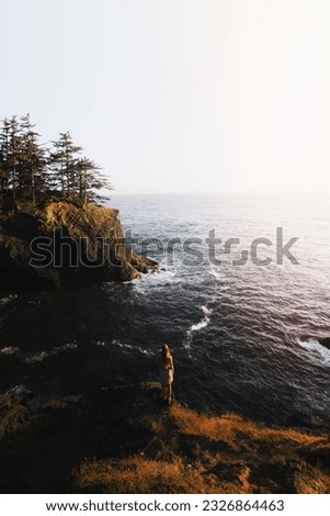 Woman standing alone on a seacliff