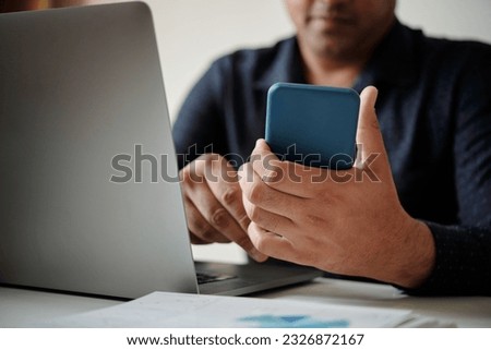 Closeup image of businessman checking daily planner application on smartphone