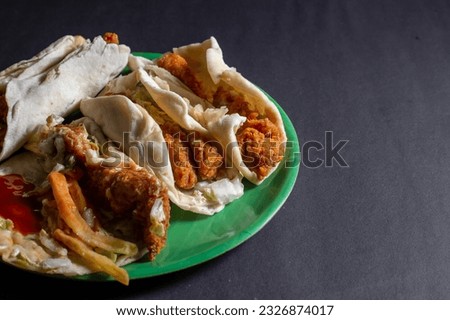 Shawarma sandwich fresh roll of, Grilled Meat and salad tortilla wrap with white sauce isolated on black background. 