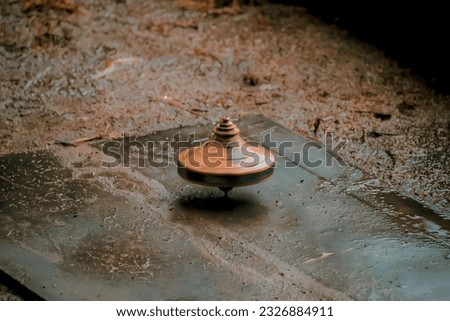 Gasing is a toy that can rotate on an axis and balance at a point. Gasing is one of the oldest toys found in various archaeological sites and can still be recognized Royalty-Free Stock Photo #2326884911