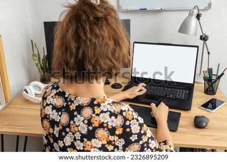 Woman working at home office as designer, photo editor, etc