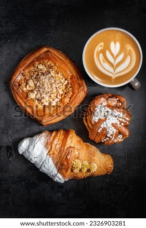 Baked pastries with cup of coffee. Freshly cooked bakery. Home cooked bakery for morning breakfast. 
