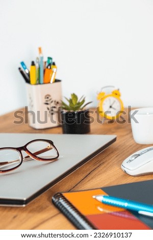 the closed notebook computer was placed on the desk in the office, concept, end of work, vertical photo
