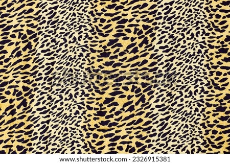 Texture and image of leopard or cheetah animal skin on fabric. Popular leopard print cheetah fabric, close up