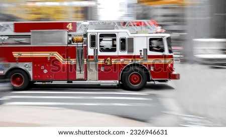 Fast movement of a fire truck along a city street Royalty-Free Stock Photo #2326946631