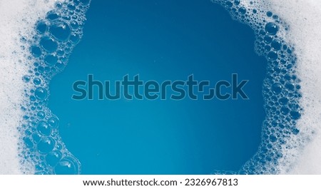 Detergent foam bubble on water. Blue background, Soap sud Royalty-Free Stock Photo #2326967813
