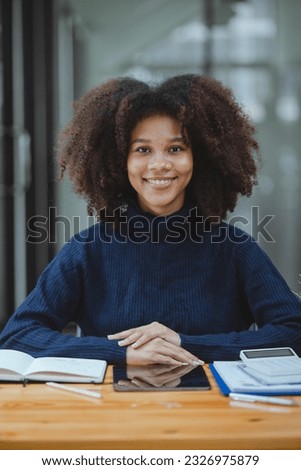 Young African American businesswoman working with pile of documents at office workplace, business finance and accounting concepts.