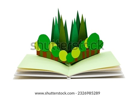 Trees in a pop-up picture book, isolated on white. (The paper craft in the book was made by myself.) Royalty-Free Stock Photo #2326985289