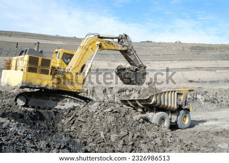over burden loading in coal mine from excavator into truck, coal mine industry Royalty-Free Stock Photo #2326986513