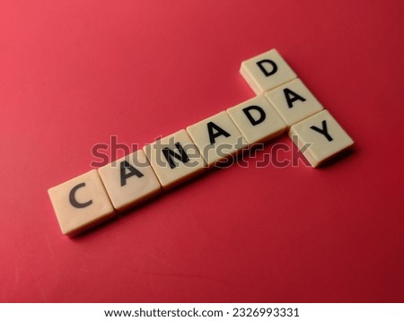 Closeup toys letters with the word CANADA DAY on a red background
