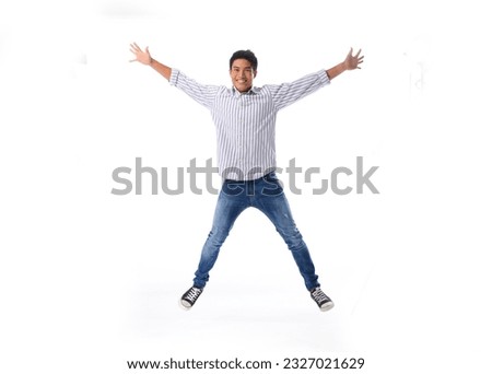 A young man jumps up on a white background. Royalty-Free Stock Photo #2327021629
